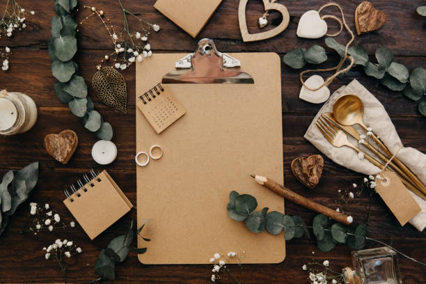 istock Flat lay Wedding planning. Craft clipboard with rustic decorations on wooden background. Vintage Greenery Wedding Details 925959566