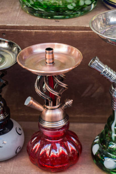 istock Group of eastern hookahs of various colors on a shelf 925971350