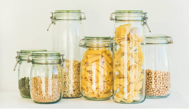 istock Uncooked cereals, grains, beans and pasta in jars 925974540