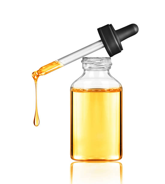 istock Oily drop falls from a cosmetic pipette, isolated on white background 925977312