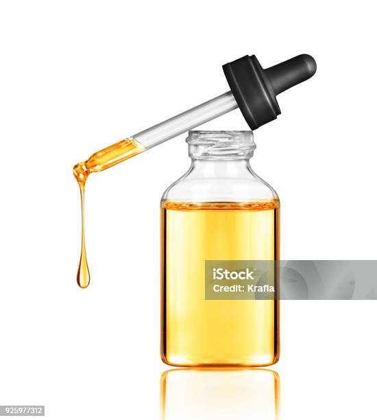 Oily Drop Falls From A Cosmetic Pipette Isolated On White Background Stock Photo - Download Image Now