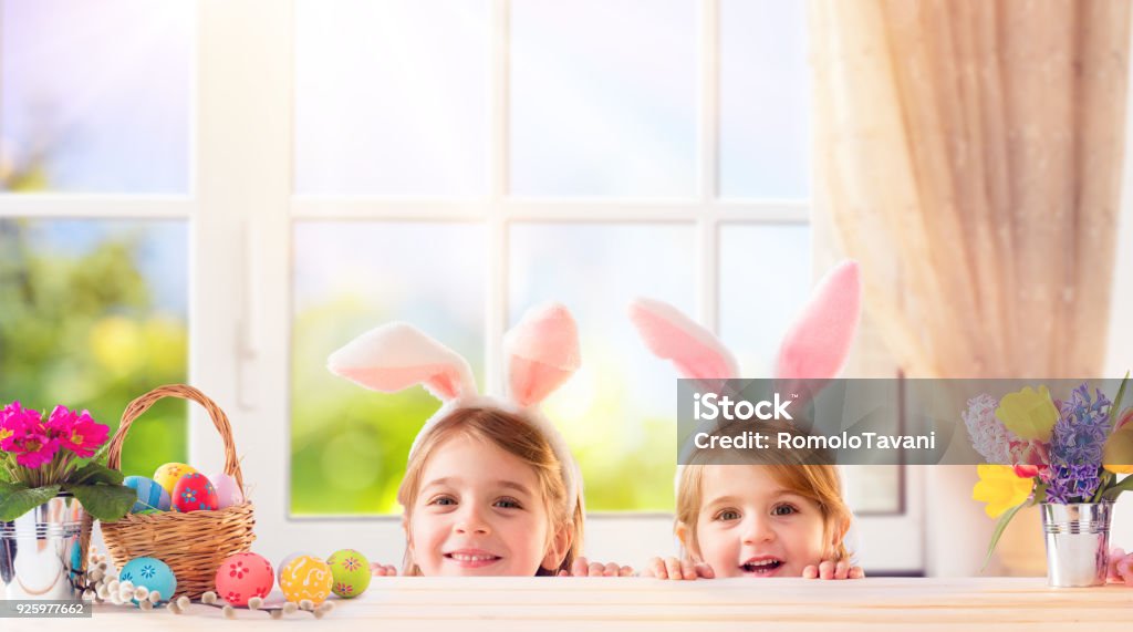 Funny Children With Bunny Ears Playing At Home Two Sisters In Domestic Life Playing With Bunny Costume Easter Stock Photo