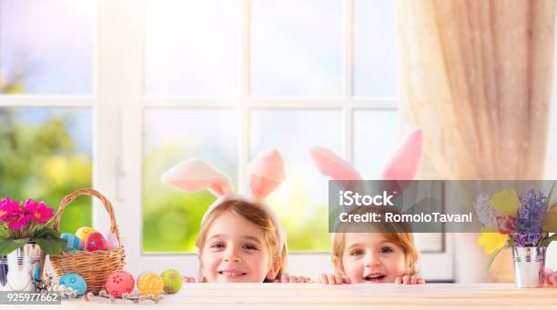 Funny Children With Bunny Ears Playing At Home Stock Photo - Download Image Now - Easter, Family, Window