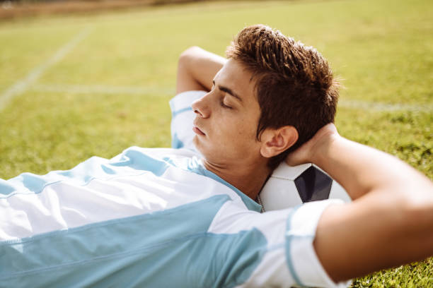 istock soccer player resting on the pitch 925984282