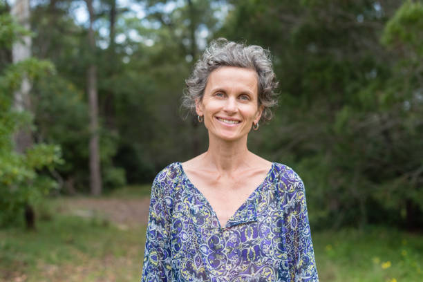 istock Middle aged woman smiling in nature 925988200