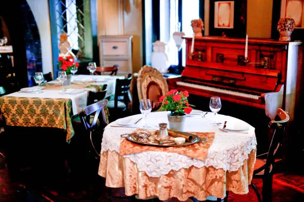 Table for two and piano in restaurant interior