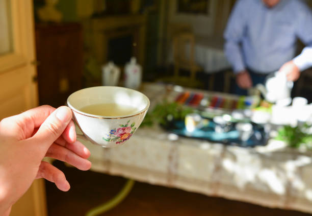 istock A female hand holds a porcelain mug with green tea 926001340
