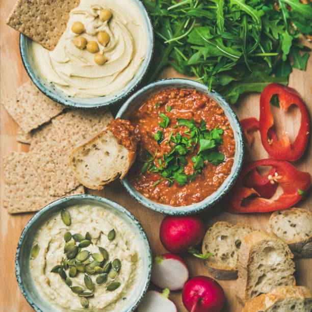istock Flat-lay of Vegetarian dips hummus, babaganush, muhammara, square crop 926010168