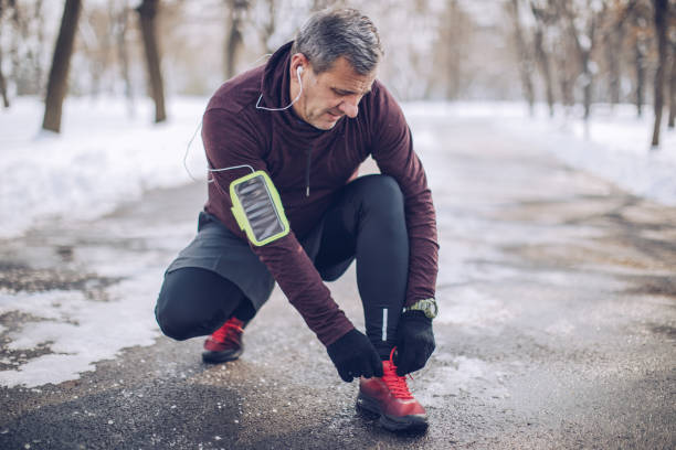 istock Senior man athlete tying shoelace in park 926010326