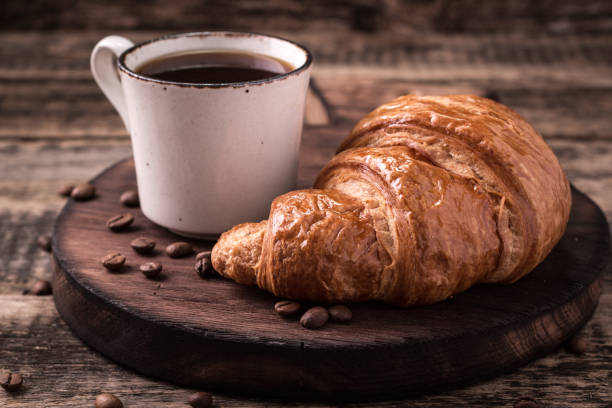 istock Breakfast with coffee and croissants on wooden vintage table 926011752