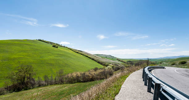 istock Asphalt road between meadow in Italy 926015538