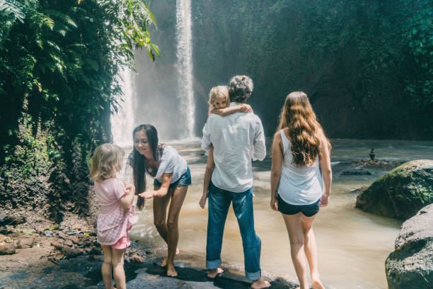 istock Family with three daughters  looking at waterfall in Bali 926016002