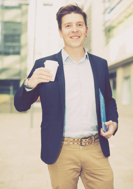 istock Professional man in jacket walking with coffee 926016288