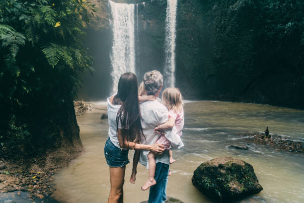 istock Family with three daughters  looking at waterfall in Bali 926016804