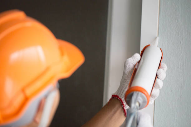 Construction workers install doors - windows and use silicon and sealant. Construction workers install doors - windows and use silicon and sealant. sealant photos stock pictures, royalty-free photos & images