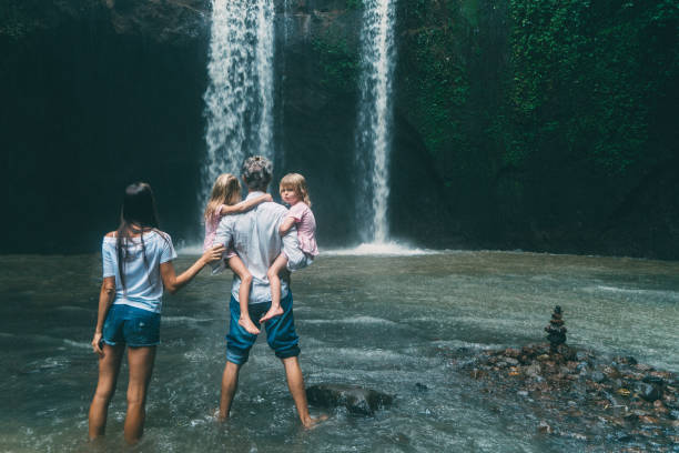 istock Family with two little  daughters  resting  near  waterfall in Bali 926022794