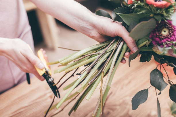 istock Florist cutting floral stems in bouquet 926023210