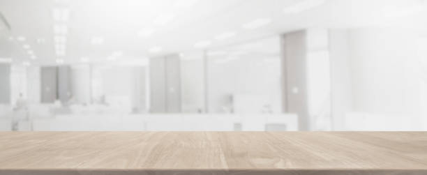 istock Empty wood table top and blurred bokeh office interior space banner background - can used for display or montage your products. 926023298