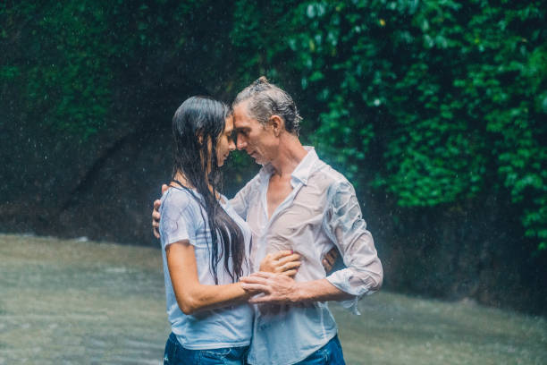 istock Mature couple standing near waterfall 926025582