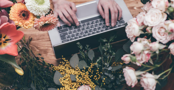 istock Crop floral shop worker using laptop 926025592