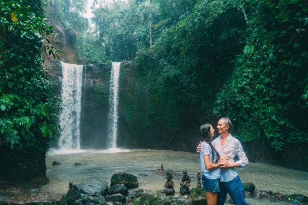 istock Mature couple standing near waterfall 926025610