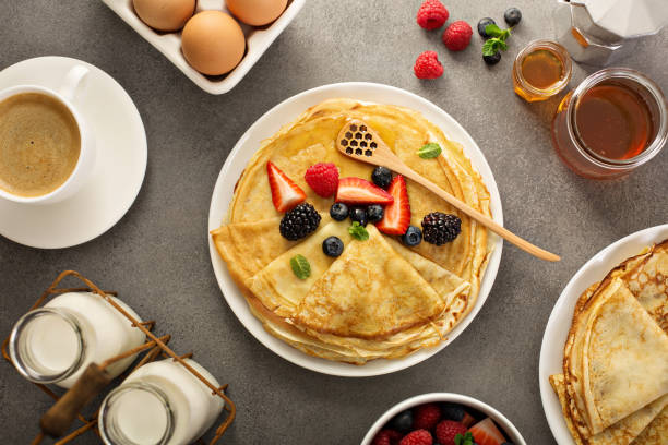 istock Thin crepes with berries and honey 926029966