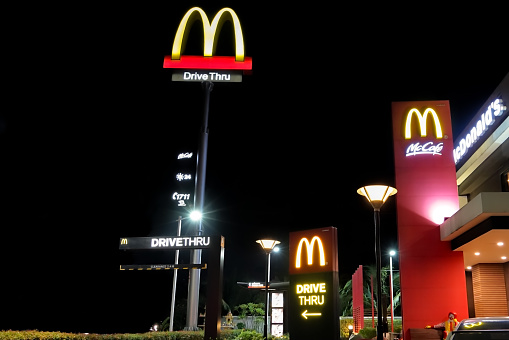 NAKHON PATHOM, THAILAND - FEB, 2018 :  McDonald's restaurant and drive thru service in night scene