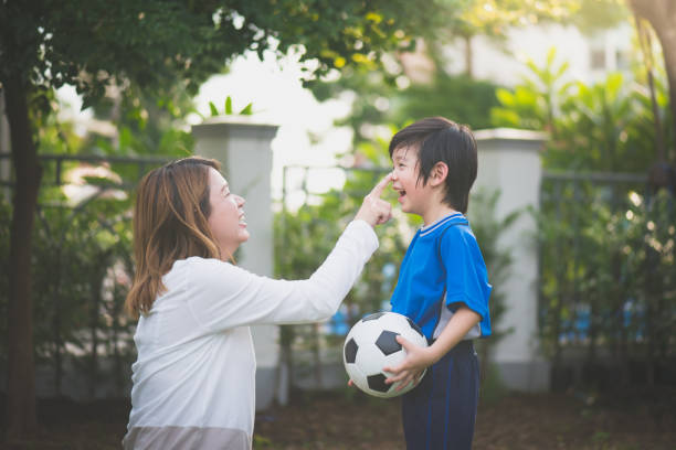 istock Asian mother and son Playing Soccer 926034010
