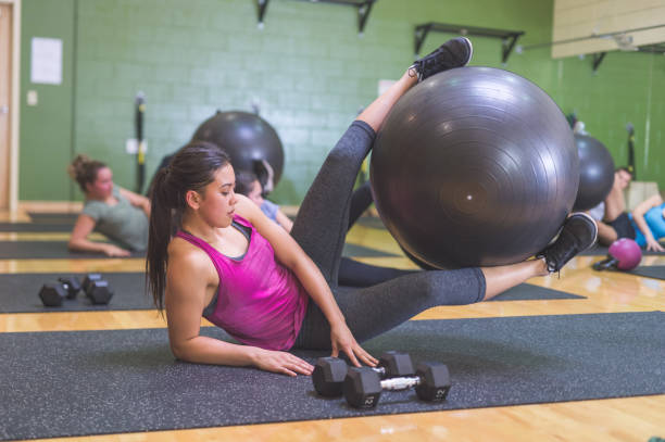 istock Co-ed Group Exercising Together at Fitness Facility 926055500