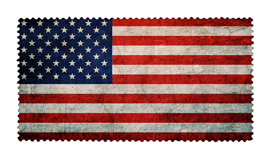 Flag of the United States on grunge postage stamp background isolated
