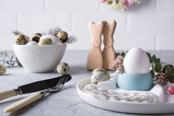 istock Homemade easter cookies in the shape of  a  funny  rabbit  on white plate. Easter  festive table setting. Holiday decorations. 926058828