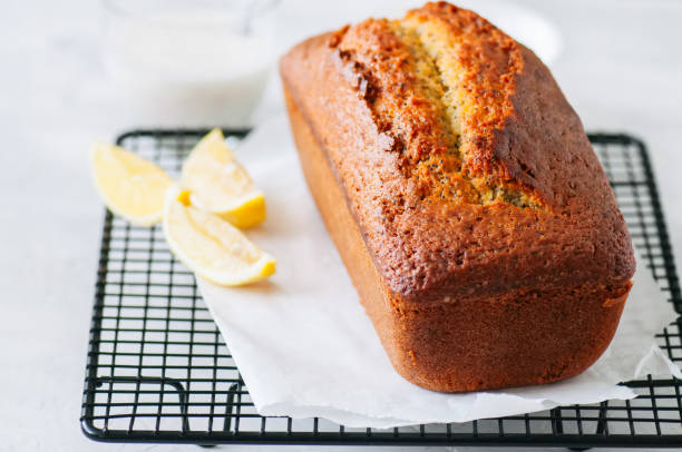 istock Homemade lemon poppy seed pound cake on a wire rack. White stone background. 926058912