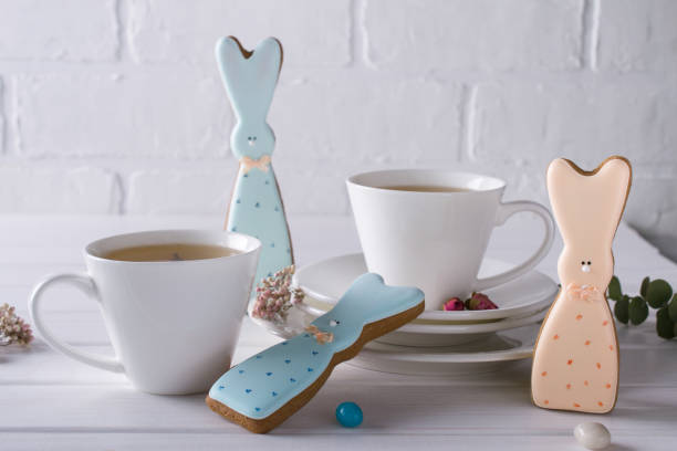 istock Easter bunny cookies and cup of tea. Celebration breakfast table setting. Holiday decorations. 926059052