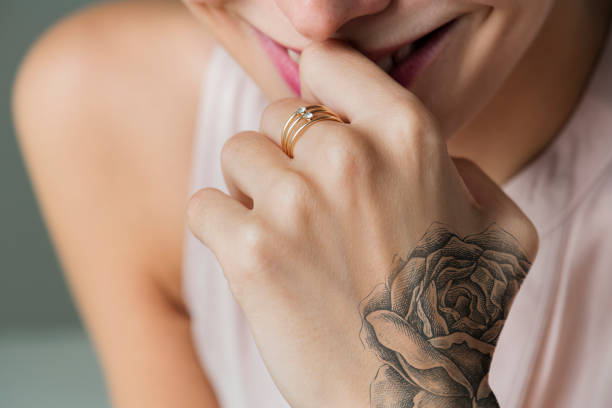 Closeup of hand tattoo of a woman Closeup of hand tattoo of a woman wrist tattoo stock pictures, royalty-free photos & images