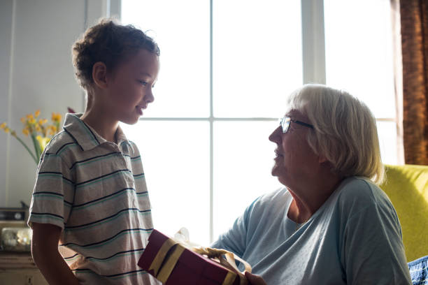 istock Grandson giving a gift to his grandma 926065568