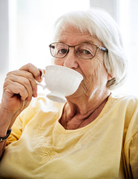istock Senior woman sipping tea while looking at the camera 926065730