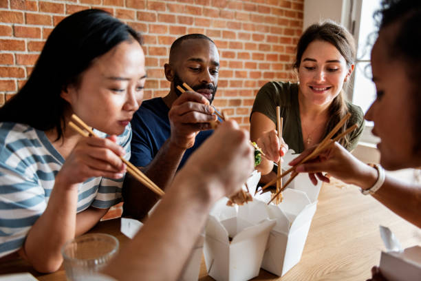 Friends eating Chow mein together Friends eating Chow mein together chinese takeout stock pictures, royalty-free photos & images