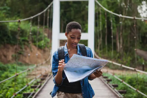 Photo of African American woman looking at a map travel and explore concept