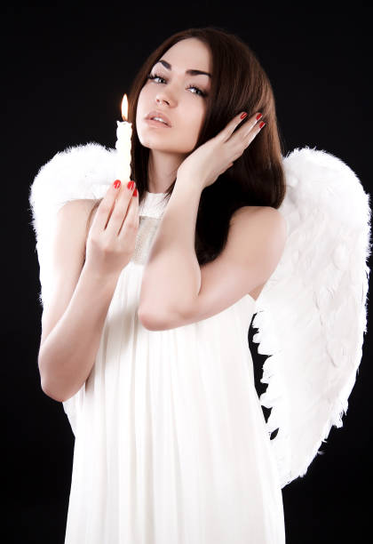istock Beautiful young angel with a candle 926066436