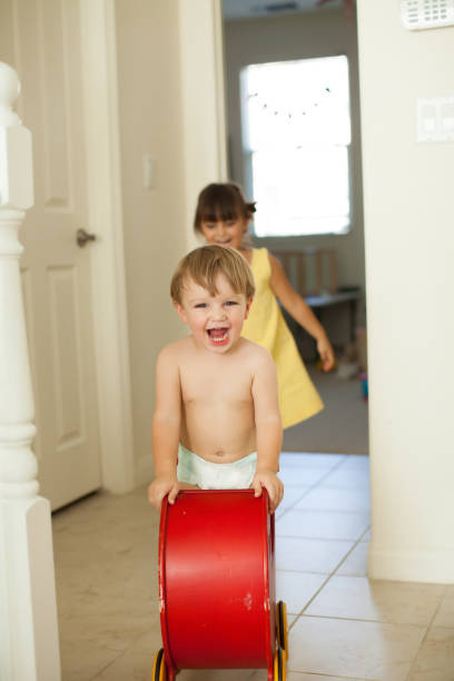 istock Toddler siblings playing together at home happily. 926066632