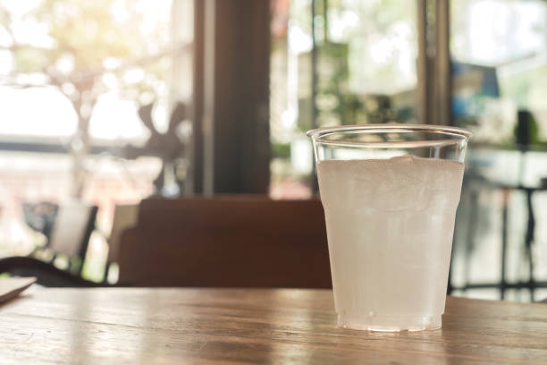 istock Glass of water with Ice cube on cafe blurred background. 926067008