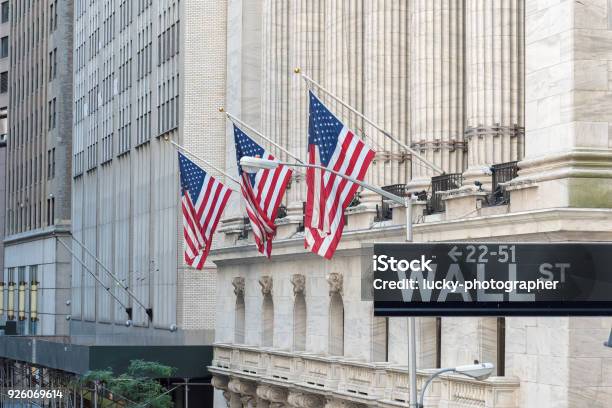 Wall Street Sign In New York City With New York Stock Exchange Background Stock Photo - Download Image Now