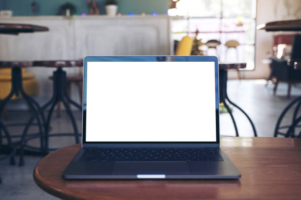 istock Mockup image of laptop with blank white desktop screen on wooden table in modern cafe 926070146