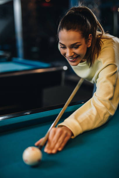 istock Young happy woman playing billiard in a pool hall. 926070246