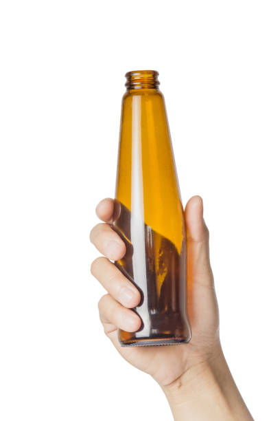 istock Woman's hand holding empty alcohol bottle transparent on white background, File contains a clipping path. 926070714