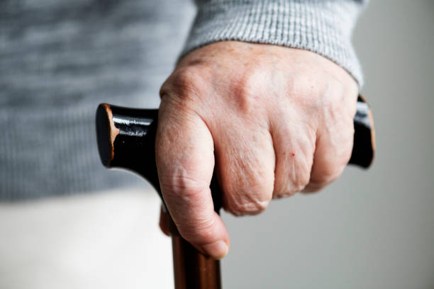 istock Closeup of elderly hand holding a walking stick 926071032
