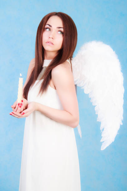 istock Beautiful young angel holding a candle 926073188