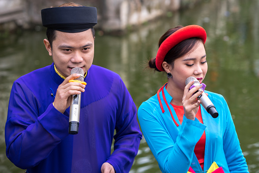 Hanoi, Vietnam - Feb 9, 2017: Folk singers singing Bac Ninh duets, folk singing on the boat in La Phu village, Hoai Duc. Intangible Heritage of Humanity.