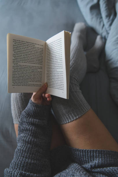 istock woman read book in bed with grey sheets 926073940