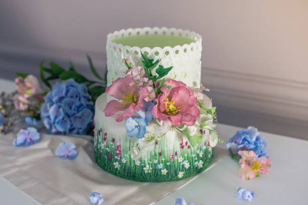 istock Wedding spring cake decorated with colorful flowers and hydrangeas. Desserts for a festive summer mood 926077116